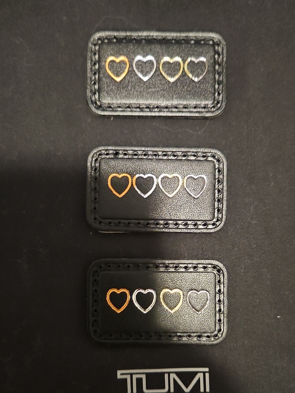 Tumi Black Leather Patches with Gold & Silver Heart Accents.  $10 Each
